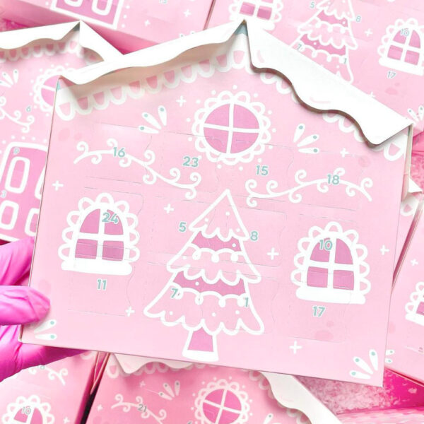 Front view of our vibrant 24 cavity 3D Pink Candy Cane House Advent Calendar. Inspired by a gingerbread house