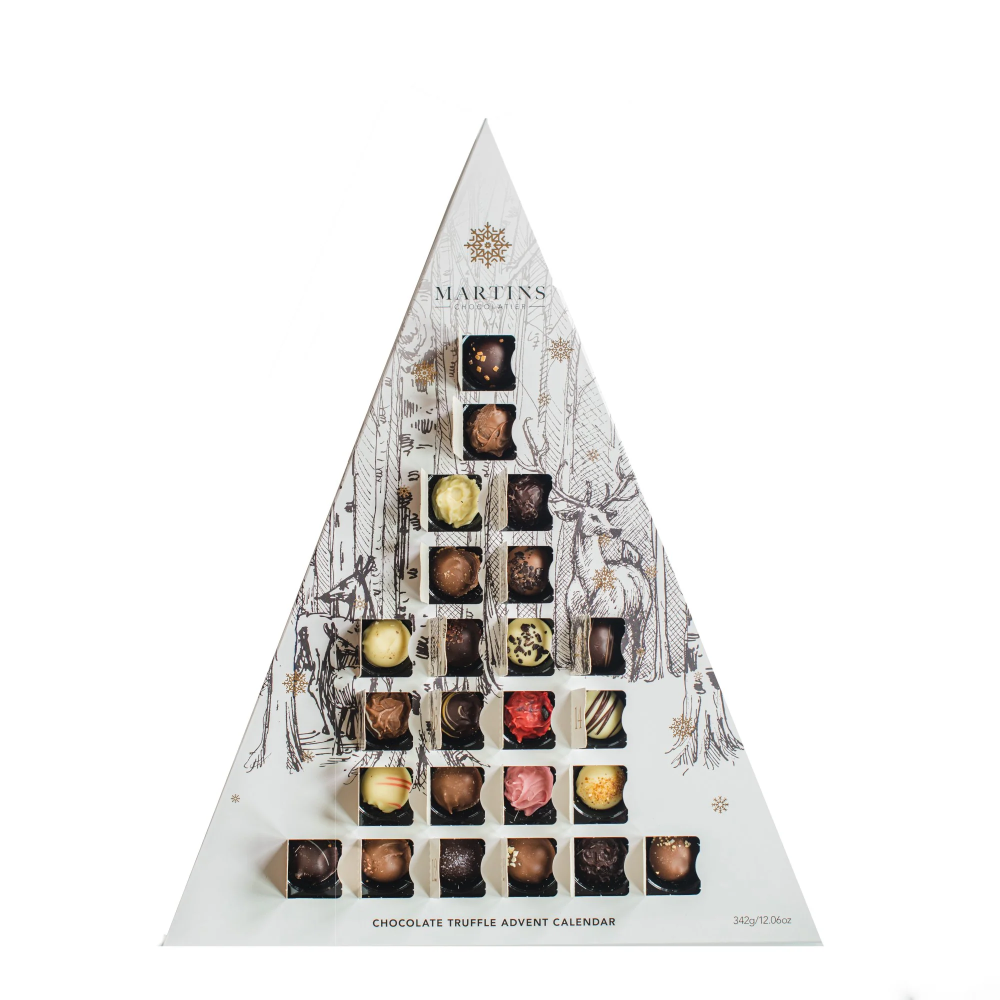 Martins Chocolatier's White Stag Triangle 24 Day Advent Calendar with Bright Gold foil detailed snowflakes & numbers. In a festive winter scene